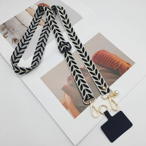 Beige adjustable mobile phone lanyard with black leaf pattern and gold hardware