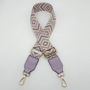 Detail of adjustable purple geometric diamond woven strap with golden metal hardware