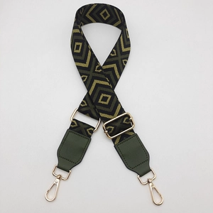 Adjustable wide canvas shoulder strap with green diamond pattern and gold hardware