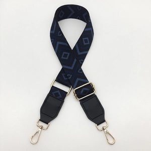 Detail showing blue and black diamond jacquard strap with gold metal swivel snap hooks