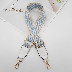 Close-up of bohemian blue floral jacquard strap with white leather and gold hardware