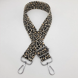 Detail of adjustable leopard print bag strap with silver metal swivel hooks and buckles