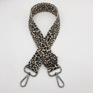 Detail of leopard print woven strap with gunmetal lobster clasps and adjustable buckle