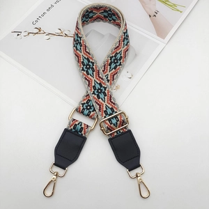 Detail of jacquard woven strap with ethnic geometric patterns and gold lobster hooks