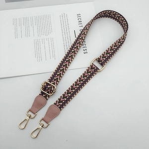 Adjustable wide woven shoulder strap with purple chevron pattern and pink leather ends