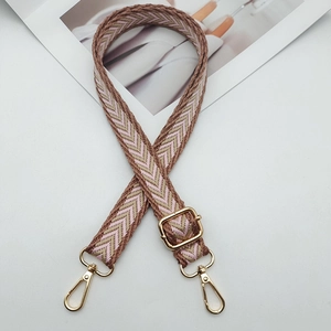 Close-up of pink and coffee herringbone nylon strap with gold metal swivel hooks