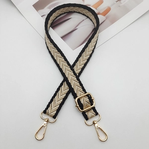 Adjustable nylon shoulder strap with yellow chevron weave and gold metal hooks