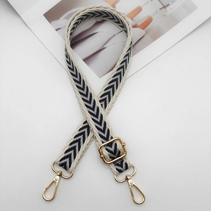 Adjustable black and white chevron pattern shoulder strap with gold metal lobster hooks