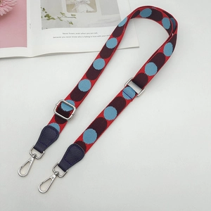 Adjustable woven nylon shoulder strap with colorful polka dot patterns and metal hooks