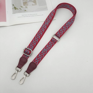 Adjustable red and blue chevron woven strap with silver buckle and leather ends