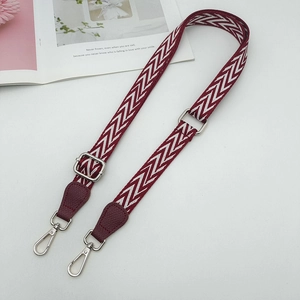 Adjustable burgundy woven shoulder strap with zigzag pattern and leather swivel hooks