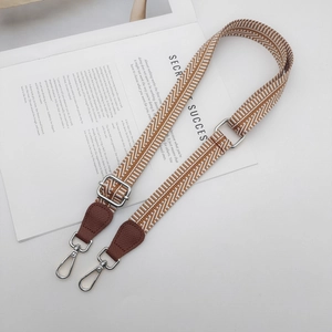 Adjustable wide woven shoulder strap with geometric pattern and brown leather details