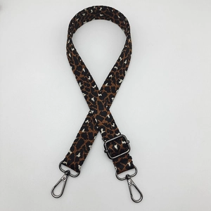 Detail of adjustable leopard print shoulder strap with black metal lobster claw clasps