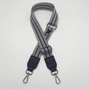 Adjustable canvas bag strap with black and white geometric patterns and metal hooks