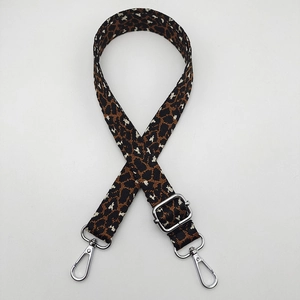 Detail of adjustable leopard print bag strap featuring silver metal swivel lobster clasps