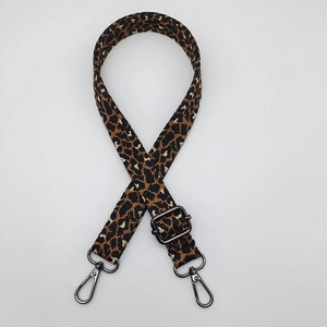 Detail of adjustable leopard print bag strap with high-density canvas and metal hooks