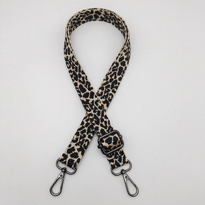 Detail of adjustable leopard print canvas strap with gunmetal swivel snap hooks