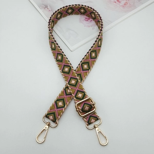 Detail of diamond pattern woven shoulder strap with high-quality gold metal buckles