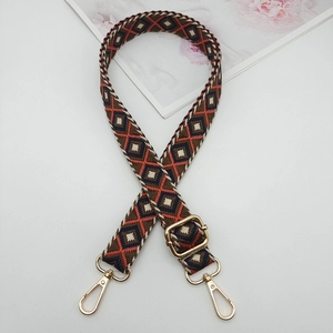 Close-up of a 2.5cm geometric diamond woven strap with premium gold metal hardware