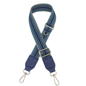 Adjustable geometric woven canvas shoulder strap with navy blue accents and gold hardware