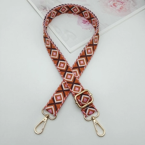Ethnic geometric pattern bag strap with gold metal hooks on a stylish background