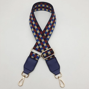 Adjustable wide woven shoulder strap with blue and burgundy checkerboard pattern