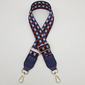 Adjustable checkerboard shoulder strap with red and blue weave and gold metal hooks