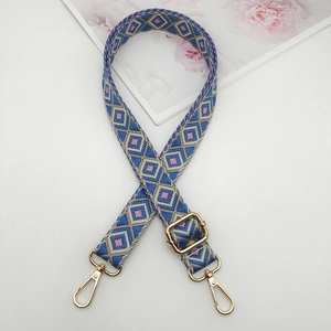 Detail of adjustable 2.5cm woven geometric diamond shoulder strap with gold lobster clasps