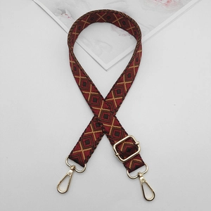 Close-up of 2.5cm red and yellow geometric diamond pattern woven strap with gold metal buckles