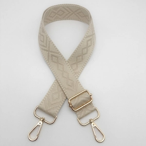 Detailed close-up of beige woven bag strap with diamond texture and gold metal hooks