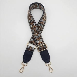 Detail of ethnic embroidery guitar strap pattern with golden metal rotating hooks