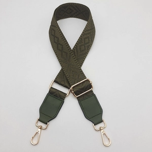 Detail of army green woven strap with geometric jacquard and golden metal hooks
