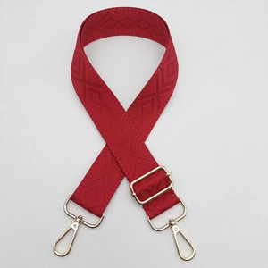 Detail of red diamond woven adjustable wide shoulder strap with golden metal lobster hooks