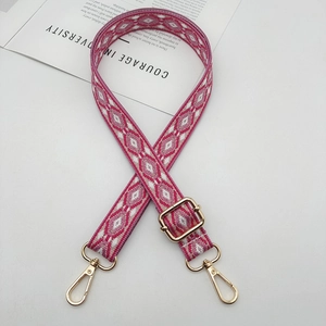 Detail of pink and white geometric jacquard strap with gold-plated adjustable buckle