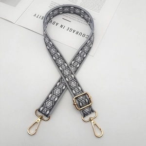 Adjustable woven shoulder strap with grey geometric pattern and gold lobster clasps