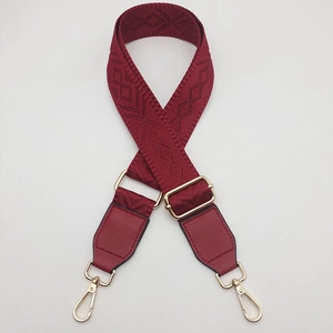 Detail of dark red wide jacquard replacement strap with golden metal lobster clasps