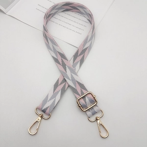 Adjustable wide shoulder strap with pink and grey geometric patterns and gold lobster clasps