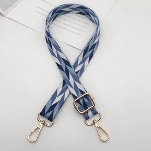 Adjustable woven shoulder strap with blue geometric fishbone pattern and gold hardware