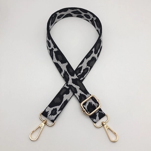 Detail of leopard jacquard strap with gold hardware and lobster clasps for bags