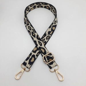 Close-up of adjustable leopard print jacquard strap with polished gold-tone metal clasps