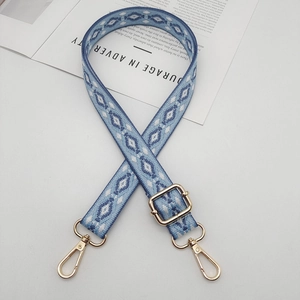 Detail of blue and white geometric woven replacement strap with gold metal lobster clasps