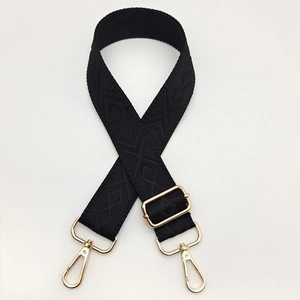 Detail of black adjustable shoulder strap with diamond pattern and gold metal lobster clasps