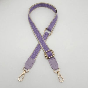 Adjustable purple woven crossbody bag strap with geometric patterns and gold metal hardware