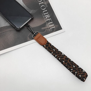 Vintage jacquard weave phone wrist strap with leather accents and matte metal hook
