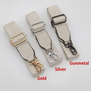 Adjustable beige woven purse strap with gold silver and black metal hardware hooks