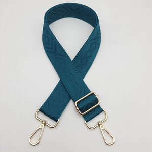 Adjustable dark cyan shoulder strap with diamond pattern and gold metal hardware