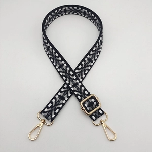 Adjustable nylon knit bag strap with black and white geometric pattern and gold hooks