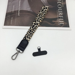 Leopard print wrist lanyard for phone with black connector patch and metal lobster clasp