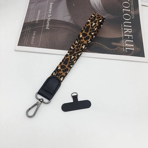 Detail of leopard print wrist strap with black leather trim and metal swivel hook