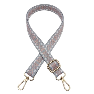 Adjustable nylon shoulder strap with pink geometric knit pattern and gold metal hooks